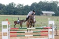 Horseman in white during the jump-off