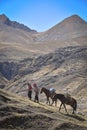 Horsemen in traditional Quechua dress follow trails through the Andes. Ausangate, Cusco, Peru