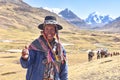 A Quechua man smiles for a photo on a trail in the Peruvian Andes. Ausangate, Cusco, Peru