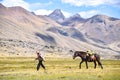 A Quechua man leads his horse along a mountain trail in the Peruvian Andes. Ausangate, Cusco, Peru