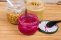 Horseradish sauce with beetroot in jar against of various mustard Royalty Free Stock Photo