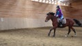 Horserider is exercising indoor