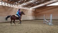 Horserider is exercising indoor