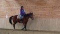 Horserider is exercising indoor