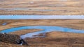 Horses and Blue sky white clouds Frozen river Yellow grass in Bayanbulak in Spring