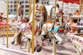 Horses on a carnival Merry Go Round. Old French carousel in a holiday park. Big roundabout at fair in amusement park. Royalty Free Stock Photo