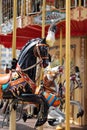 Horses on a carnival Merry Go Round. Old French carousel in a holiday park. Big roundabout at fair in amusement park. Royalty Free Stock Photo