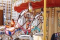 Horses on a carnival Merry Go Round. Old French carousel in a holiday park. Big roundabout at fair in amusement park. Royalty Free Stock Photo