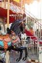 Horses on a carnival Merry Go Round. Old French carousel in a holiday park. Big roundabout at fair in amusement park. Royalty Free Stock Photo