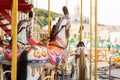 Horses on a carnival Merry Go Round. Old French carousel in a holiday park. Big roundabout at fair in amusement park. Royalty Free Stock Photo