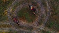 Horses with equestrians and a dog are going in circle on the autumn field Royalty Free Stock Photo