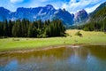 Horses graze on green field.Lake Lago di Fusine Superiore Italy