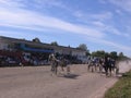 horses harnessed to a cart with a rider run at the racetrack for sports competitions in horse