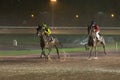 Horses race on a rainy hippodrome