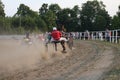 Horses and riders running at horse races