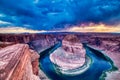 Horseshoe Bend on Colorado River at Sunset with Dramatic Cloudy Sky, Utah Royalty Free Stock Photo