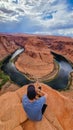 Horseshoe Bend - Tourist man with panoramic aerial view of Horseshoe bend on the Colorado river near Page in summer, Arizona, USA Royalty Free Stock Photo