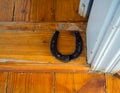 Horseshoe nailed on the threshold of the front door to the house
