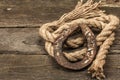 Horseshoe and vintage rope. Concept of good luck for St. Patrick`s Day. Old wooden boards background Royalty Free Stock Photo