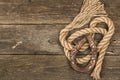 Horseshoe and vintage rope. Concept of good luck for St. Patrick`s Day. Old wooden boards background Royalty Free Stock Photo