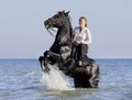 Horsewoman in the sea Royalty Free Stock Photo