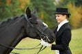 Horsewoman jockey in uniform with horse