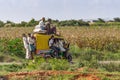 Tricycle overloaded with people and bags, Hosahalli, Karnataka, India