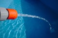 Hose filling up an empty swimming pool with water Royalty Free Stock Photo