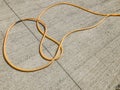 Hose for water lying on a concrete slab in the street. Material for repairs in an apartment is under construction