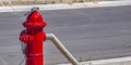 Hose and wrench secured to a red fire hydrant Royalty Free Stock Photo