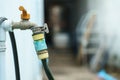 An outdoor faucet that is connected to a hose Royalty Free Stock Photo