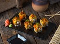 HOSHI maki served in a dish isolated on wooden background side view