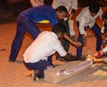 Young males light firework box Diwali celebration, Hospet, Karnataka, India