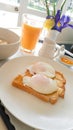 Hospice breakfast with poached eggs and porridge and orange juice
