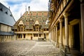 The Hospices of Beaune historic hospital, with visitors, in Beaune, Burgundy, France Royalty Free Stock Photo