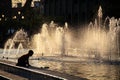 Kid playing around the Cabanas fountains and pool at sunset, Guadalajara, Jalisco, Mexico