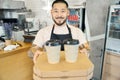 Hospitable barista holding packed food and drinks for delivery Royalty Free Stock Photo