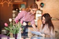 Hospitable waitress help to customer what to choose something from menu