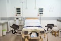 Hospital bed, obstetric chair in delivery room with electrocardiograph for monitoring heartbeat of future newborn baby Royalty Free Stock Photo