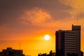 Hospital building at dusk with beautiful sunset sky. Silhouette of hospital building in the evening. Cityscape of skyscraper