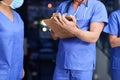 Hospital, clipboard and hands of nurse team for medical service, writing notes and diagnosis results. Healthcare, clinic