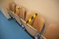 In hospital corridor chairs are blocked with adhesive tape because of Corona