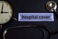 Hospital Cover on the print paper with Healthcare Concept Inspiration. alarm clock, Black stethoscope.