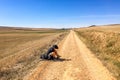 Hospital de Orbigo, Spain - A Lone Hiker, Resting and Adjusting His Hiking Gear on the Way of St. James Camino de Santiago