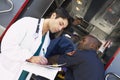 Hospital doctor taking notes paramedics Royalty Free Stock Photo