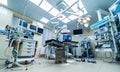 Hospital interior with operating surgery table, lamps and ultra modern devices, technology in modern clinic Royalty Free Stock Photo