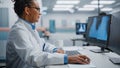 Hospital Laboratory: Black Female Medical Doctor is Working on Computer Analysing Chest, Bones X-rays on Screen.