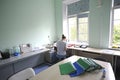 At a hospital laboratory. Lab technician performing analysis of blood samples with gas-electrolyte analyzer