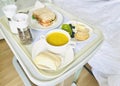 Hospital meal, breakfast including pumpkin soup sandwich fruits and crackers. Royalty Free Stock Photo