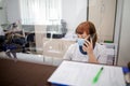 Nurse on duty speaks on the phone at the reception desk. Busy modern hospital with some of the best specialists and Medicare Royalty Free Stock Photo